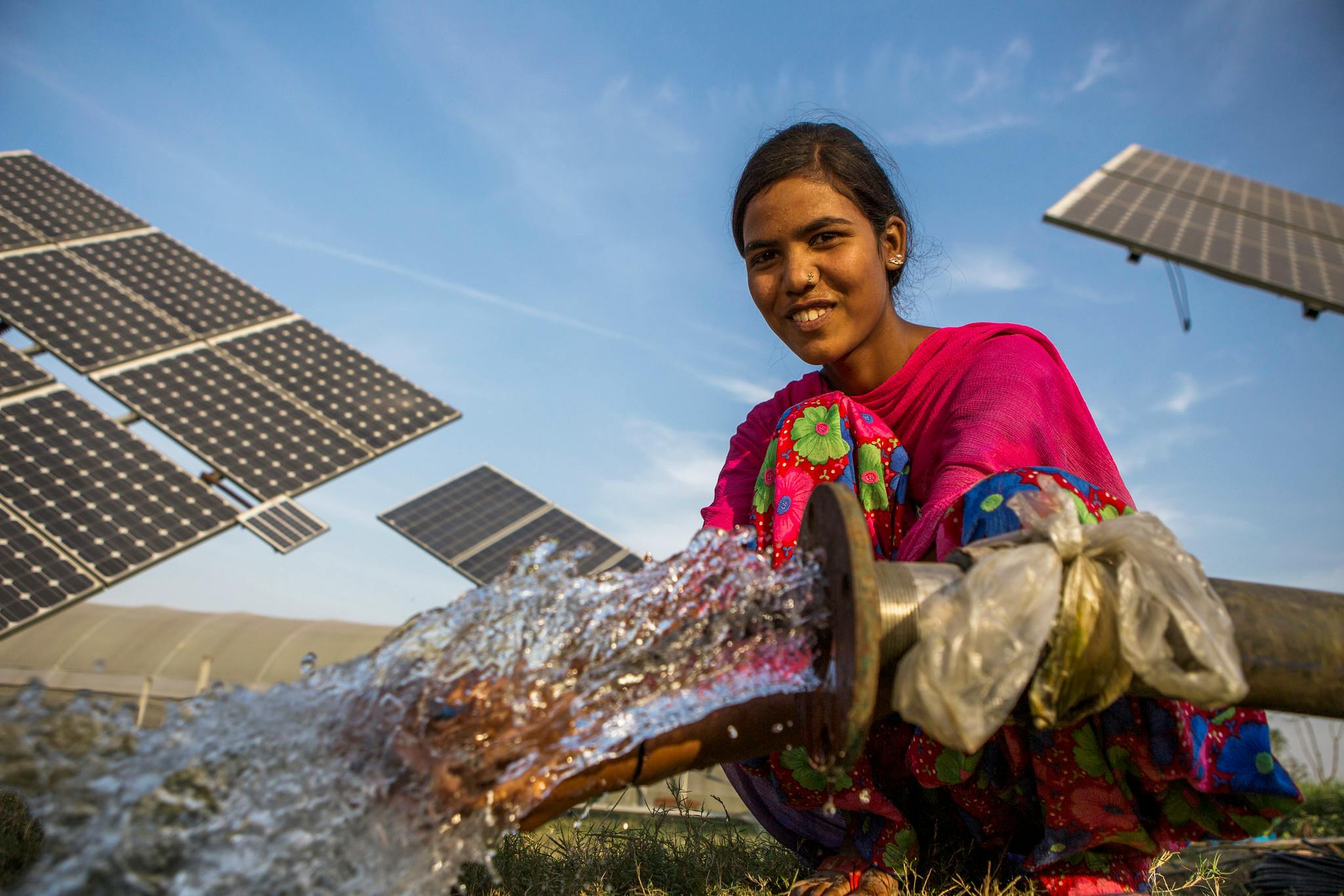 woman farmworker water pump