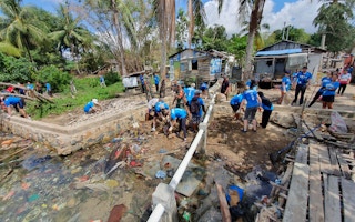 A beach clean up in Indonesia. Companies pay to have beaches cleaned to offset the plastic they cannot eliminate from their operations. Image: Seven Clean Seas