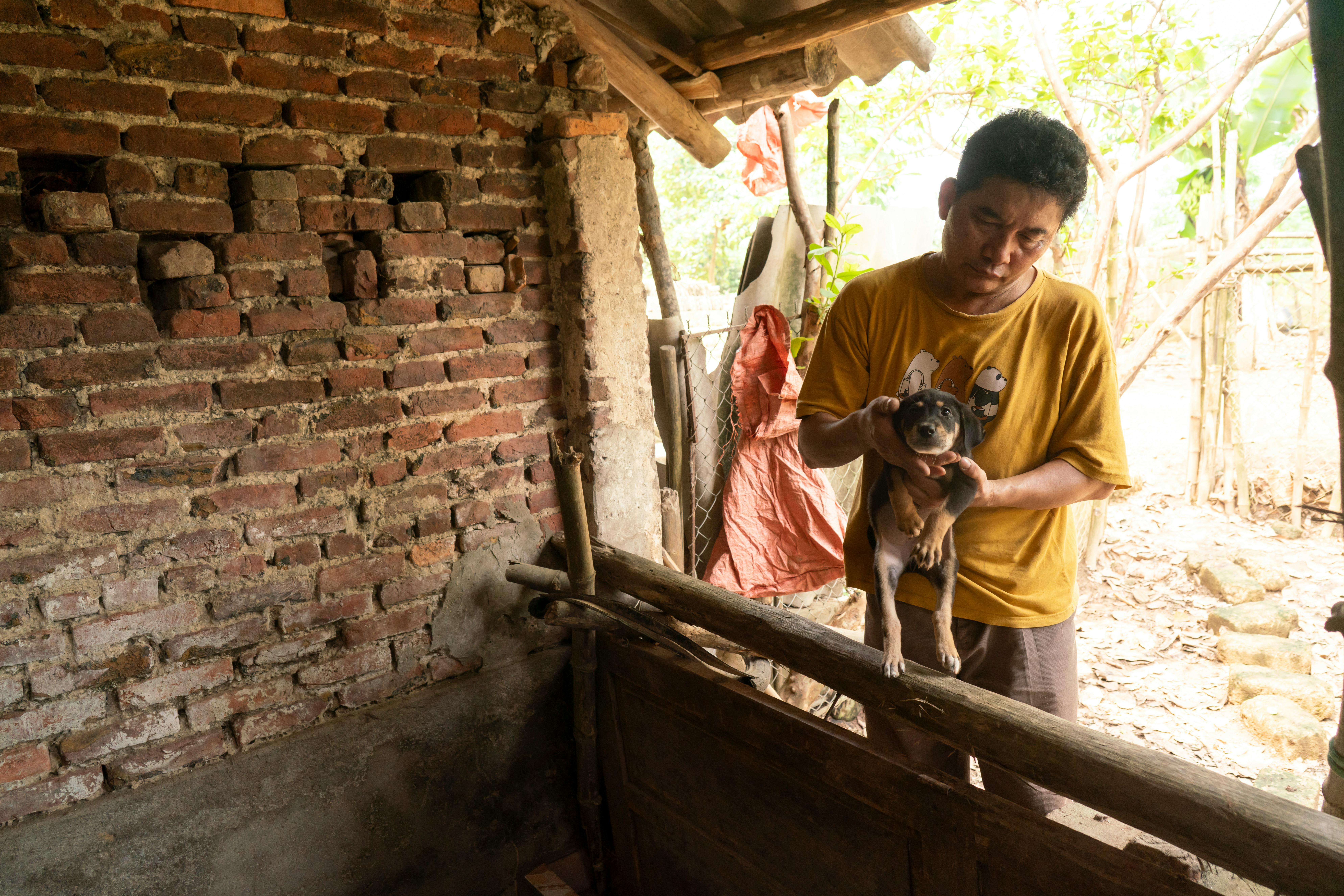 Fifty-two year-old Thái Nguyên resident Phạm Dũng holding a puppy