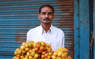 man sells vegetables in Old Ahmedabad, India