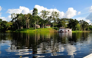 A house in the middle of a forest in the Amazon riverbank, Brazil