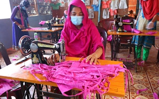 Rohingyan woman sews face masks