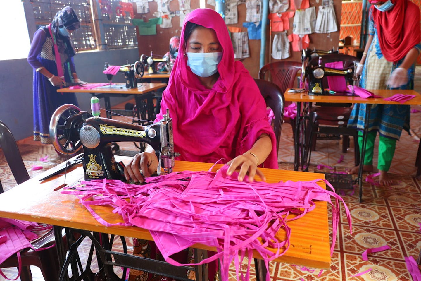 Rohingyan woman sews face masks