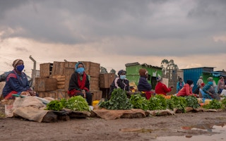 Women selling vegetables at a market in Kenya.