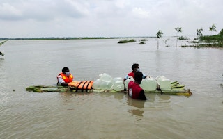 Volunteers bringing clean water to flood-stricken communities in northern Bangladesh.