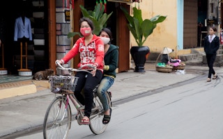 Young women cycling in Vietnam