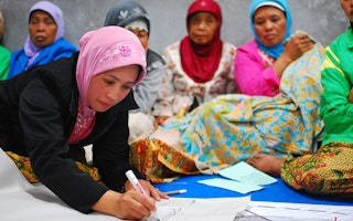 Women participate in a community meeting on village reconstruction in Yogyakarta, Indonesia.