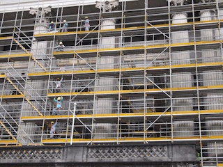 Workers on a scaffolding on a construction site in Singapore