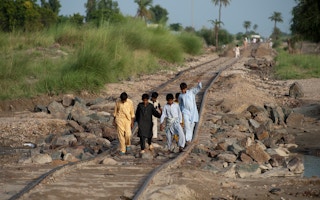 Children on railway damaged by Pakistan floods 2010