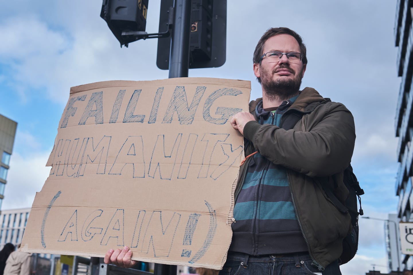 A protester holds a placard outside the COP26 climate talks, Glasgow, Nov. 2021