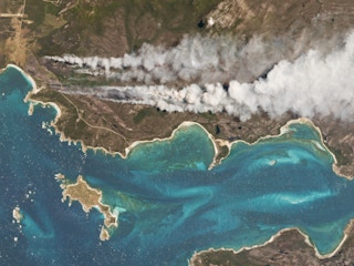 On Cape Barren Island, Australia, a vegetation fire started along the coast.