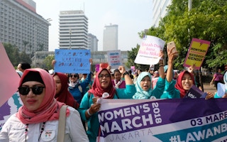 Women marching against gender-based violence in 2018
