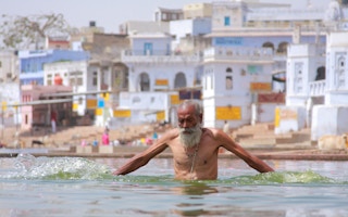 indian man bathing on a hot day