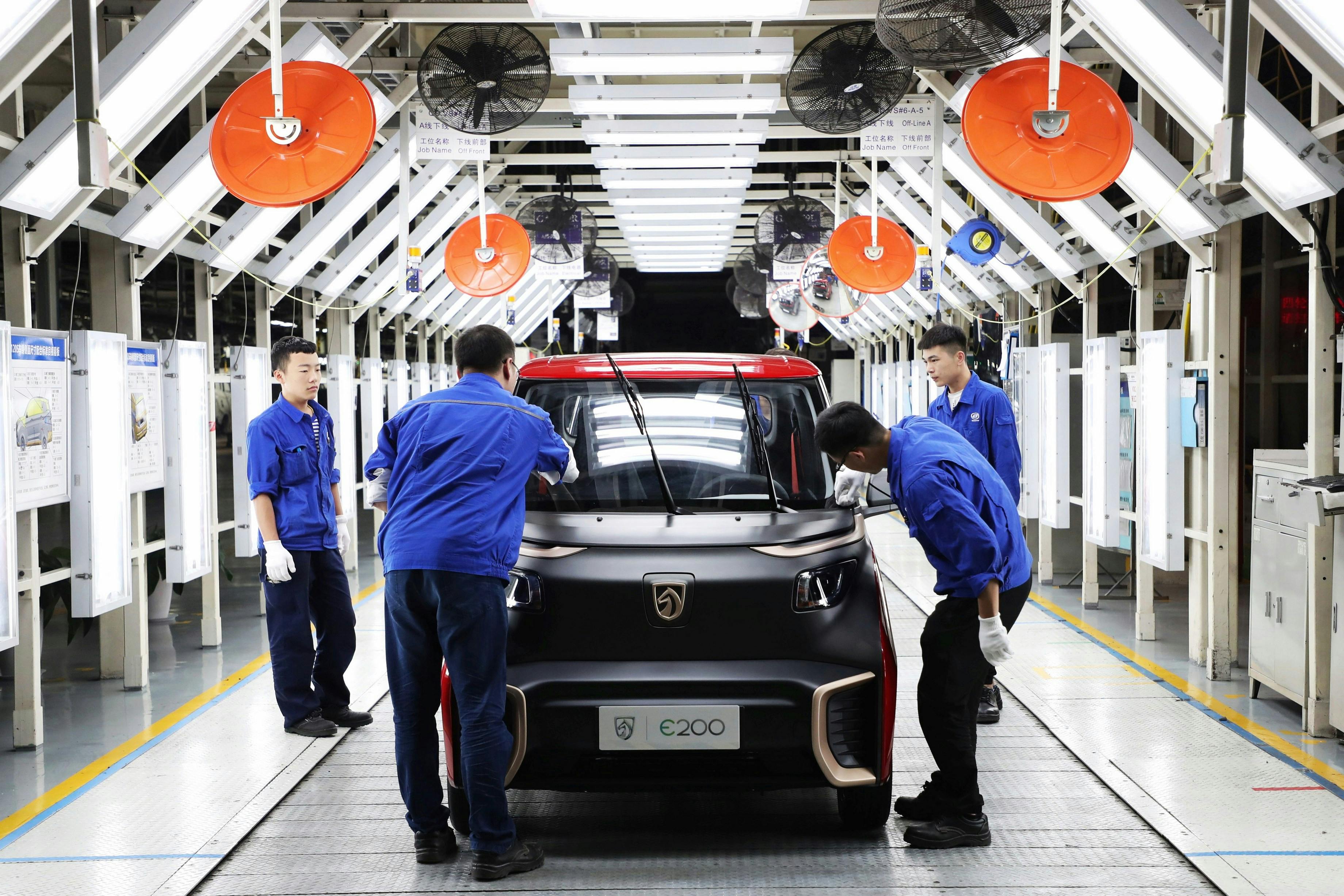 Chinese workers check EVs in Qingdao City