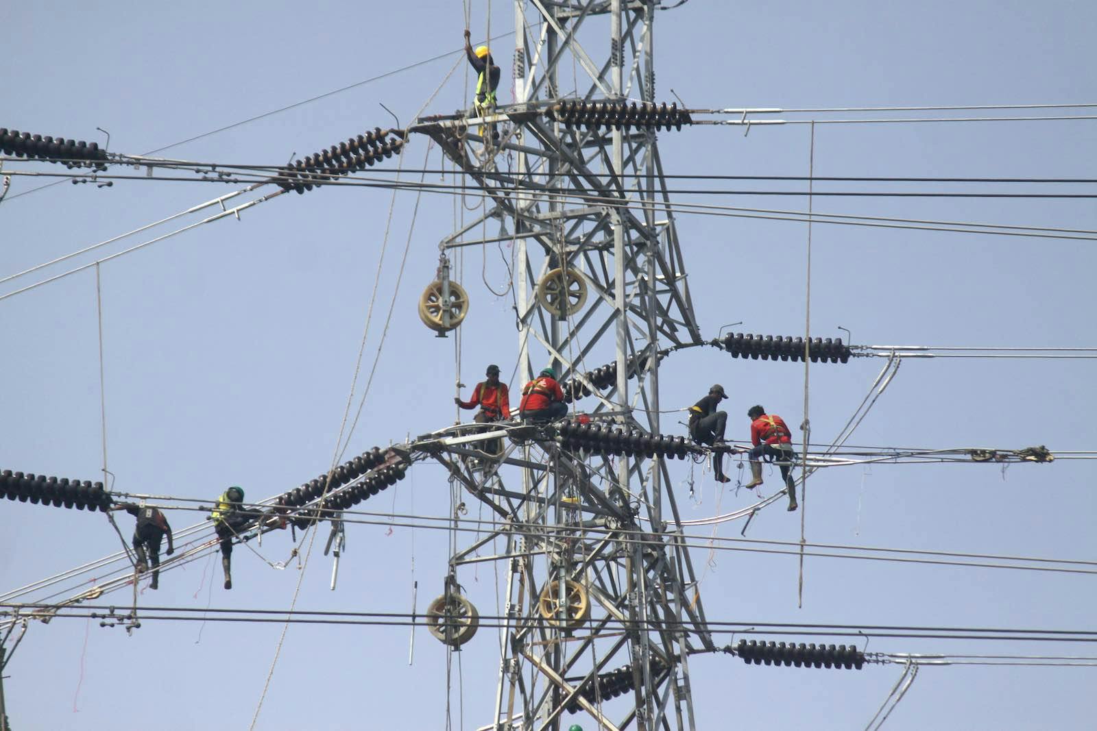 Workers installing power transmission line in Jakarta, Indonesia