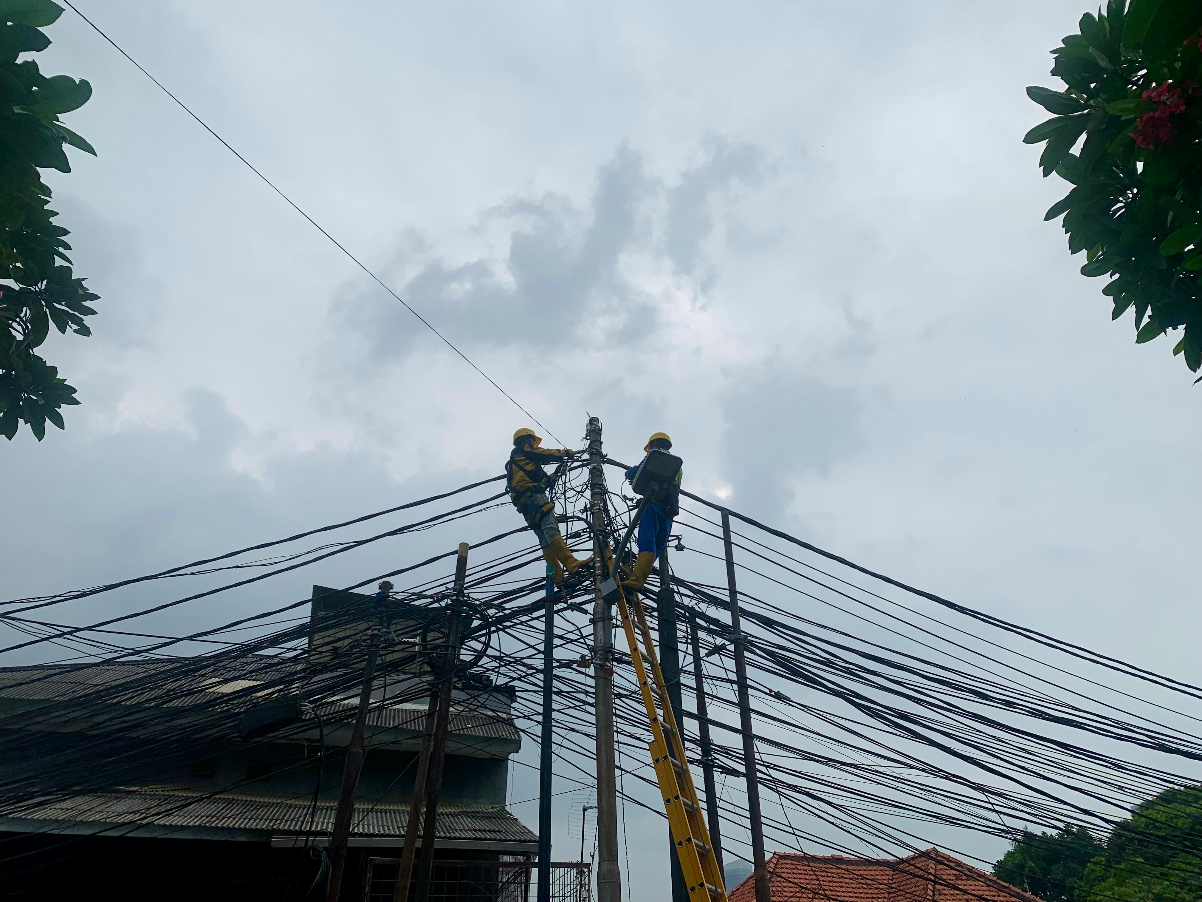 Electricians fix power lines in South Jakarta, Indonesia.