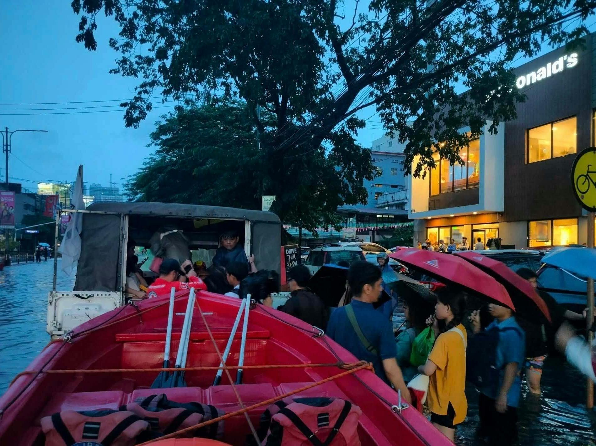 Commuters are trapped by monsoon floodwaters along UN Avenue