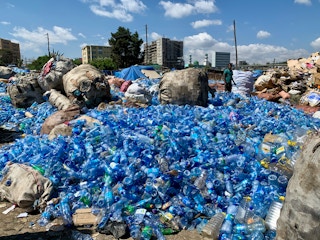 Plastic water bottles await collection for recycling in Africa.