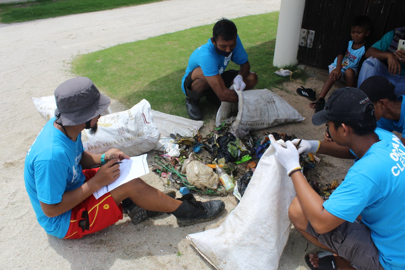 Workers weigh marine debris collected from a beach in Bintan, Indonesia. Image: Seven Clean Seas