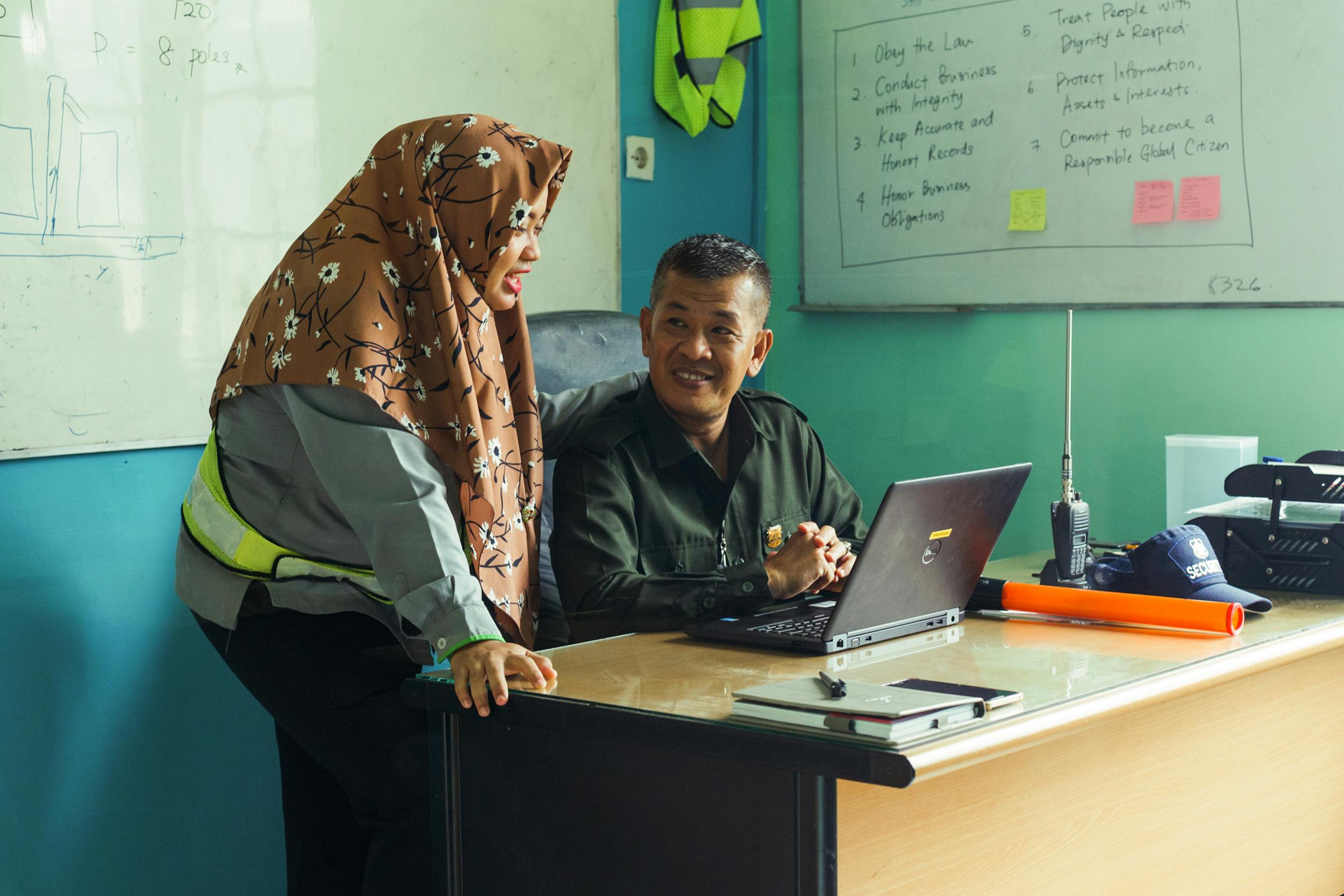 Daughter Riri Damayanti (left) and her father Syamsul Bahri (right) are colleagues at a palm oil company in South Sumatra.