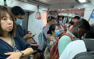 Commuters on a train in Singapore, some wearing disposable surgical masks as a protection measure from the Coronavirus. Image: Eco-Business