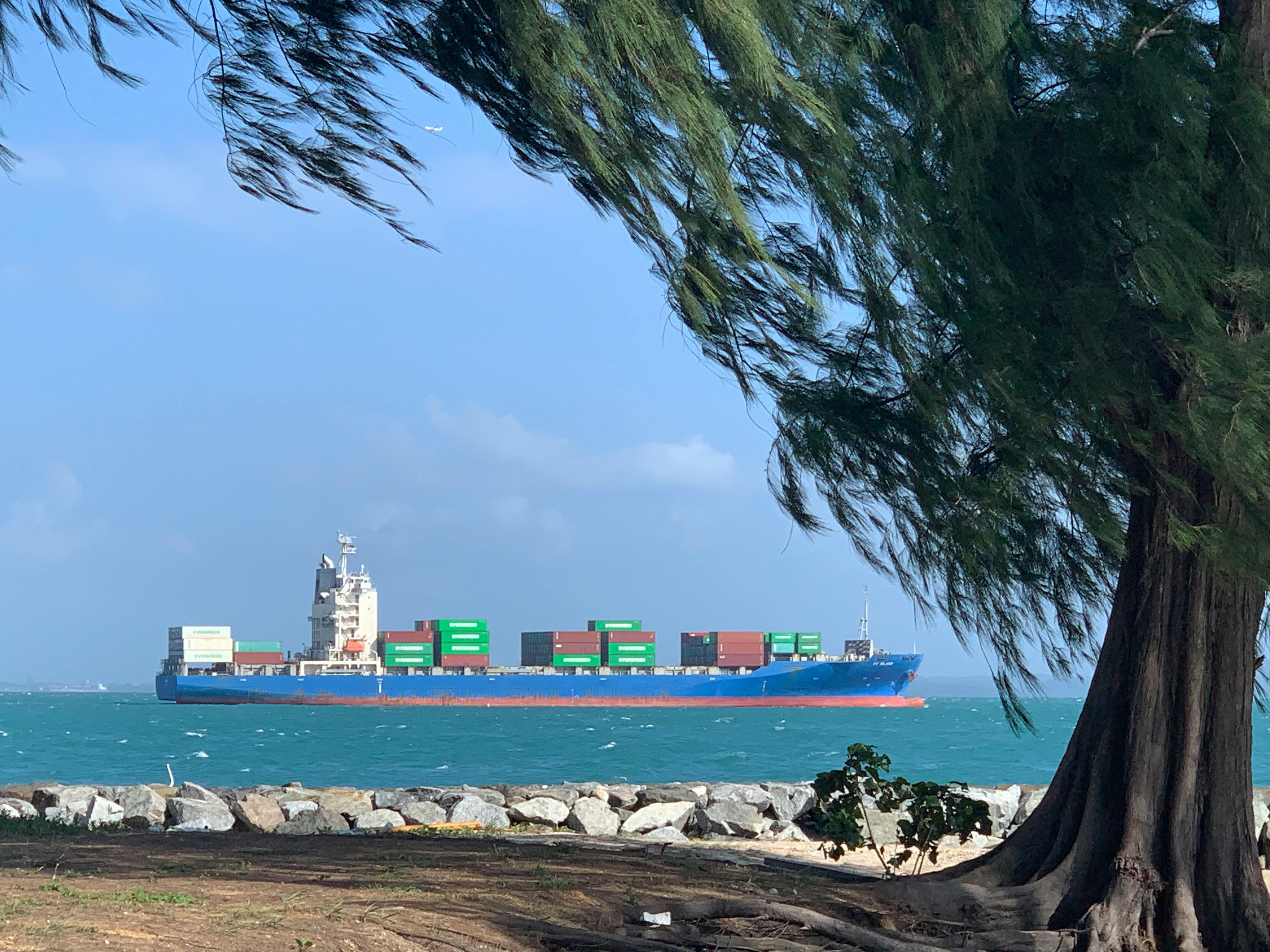 A ship passes Kusu Island off the coast of Singapore, one of the world's busiest shipping routes