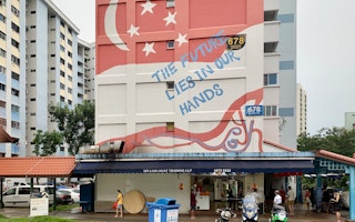 A mural painted on a wall in the heartland district of Hougang, Singapore, reads: "The future lies in our hands". Image: Robin Hicks/Eco-Business
