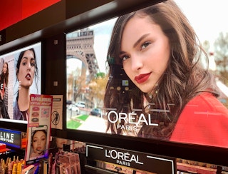 A L'Oreal display in a pharmacy in Singapore.