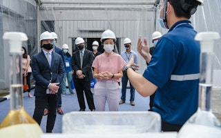 Singapore's environment minister Grace Fu (centre) is shown around the new Tes B battery recycling facility in the industrial region of Jurong.
