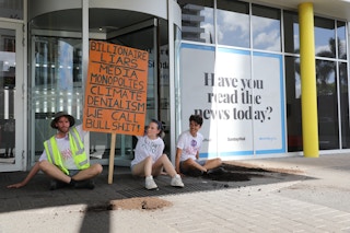 Extinction Rebellion protesters demonstrate outside of the News Corp headquarters in Bowen Hills, Brisbane, where they deposited a truckload of manure. The protesters held banners that read: "Billionaire liars. Media monopoly. Climate denial. We call bullshit." Image: XR