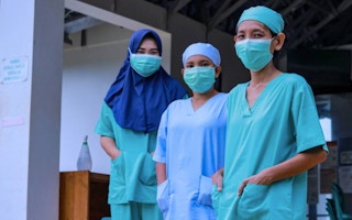 Three nurses stand for a portrait near Gunung Palung National Park in West Kalimantan, Borneo, Indonesia