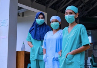 Three nurses stand for a portrait near Gunung Palung National Park in West Kalimantan, Borneo, Indonesia