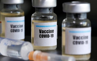Small bottles labeled with a 'Vaccine Covid-19' sticker