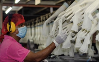 A worker makes checks at the Miditech Gloves' rubber glove factory in Malaysia in 2020.
