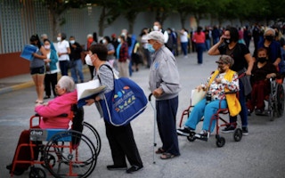 Elderly people queue for vaccination