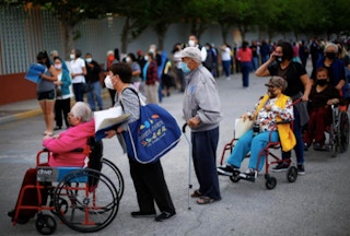 Elderly people queue for vaccination