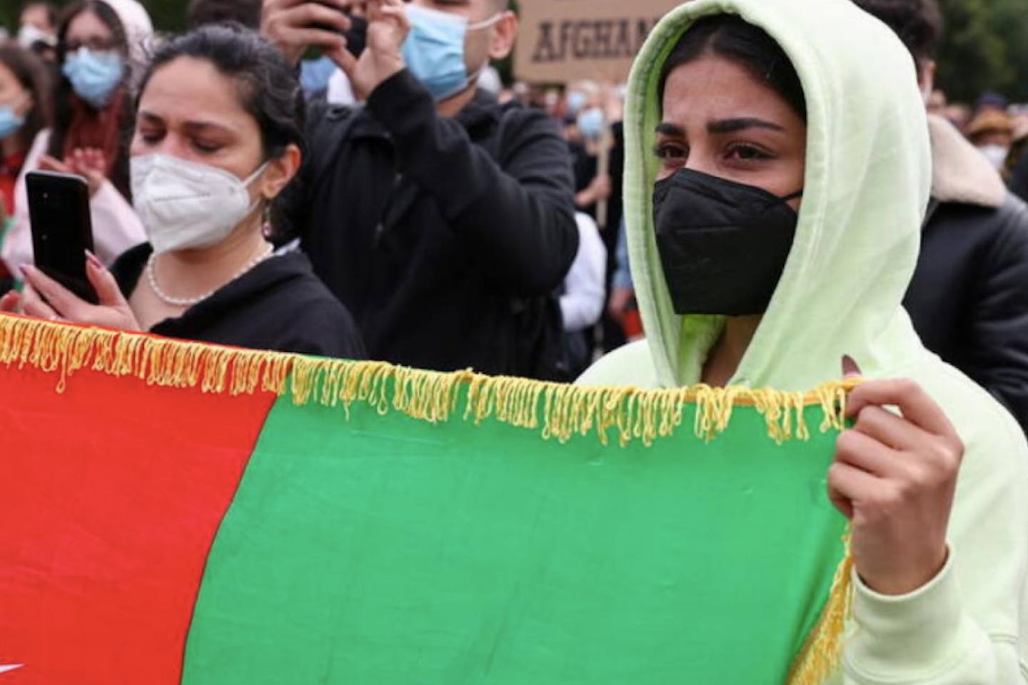 woman holds an Afghan flag