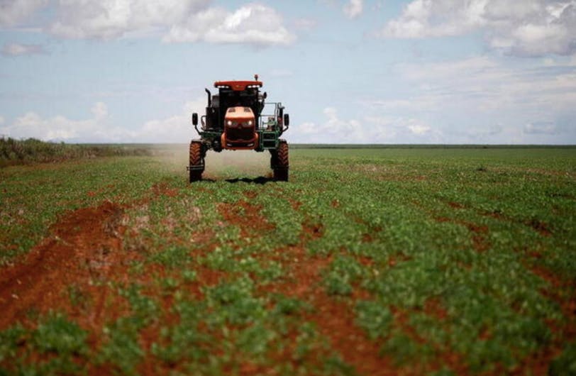 gricultural worker drives a tractor