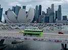 A bus heads over a bridge at Marina Bay.
