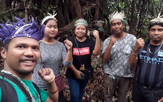 Artist and activist Shaq Koyok (left) with members of the indigenous Temuan community