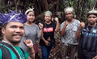 Artist and activist Shaq Koyok (left) with members of the indigenous Temuan community