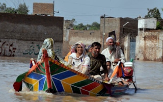 Family escaping floods in Pakistan