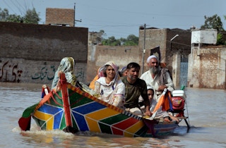 Family escaping floods in Pakistan