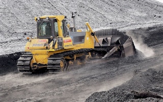 a bulldozer pushing indonesian coal