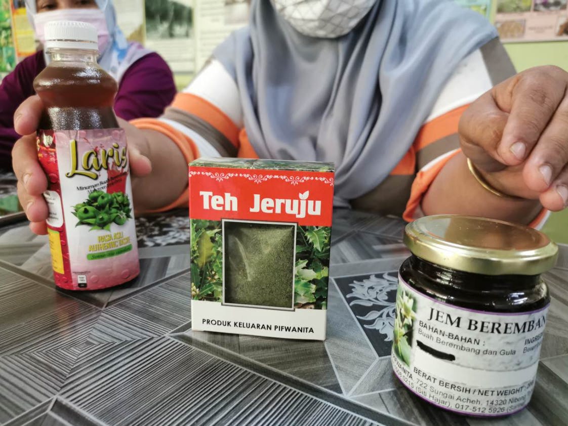 Malaysian woman showcasing mangrove-derived products