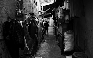 Laundry lines stretch towards the back of this unmarked alley in Tanah Abang.