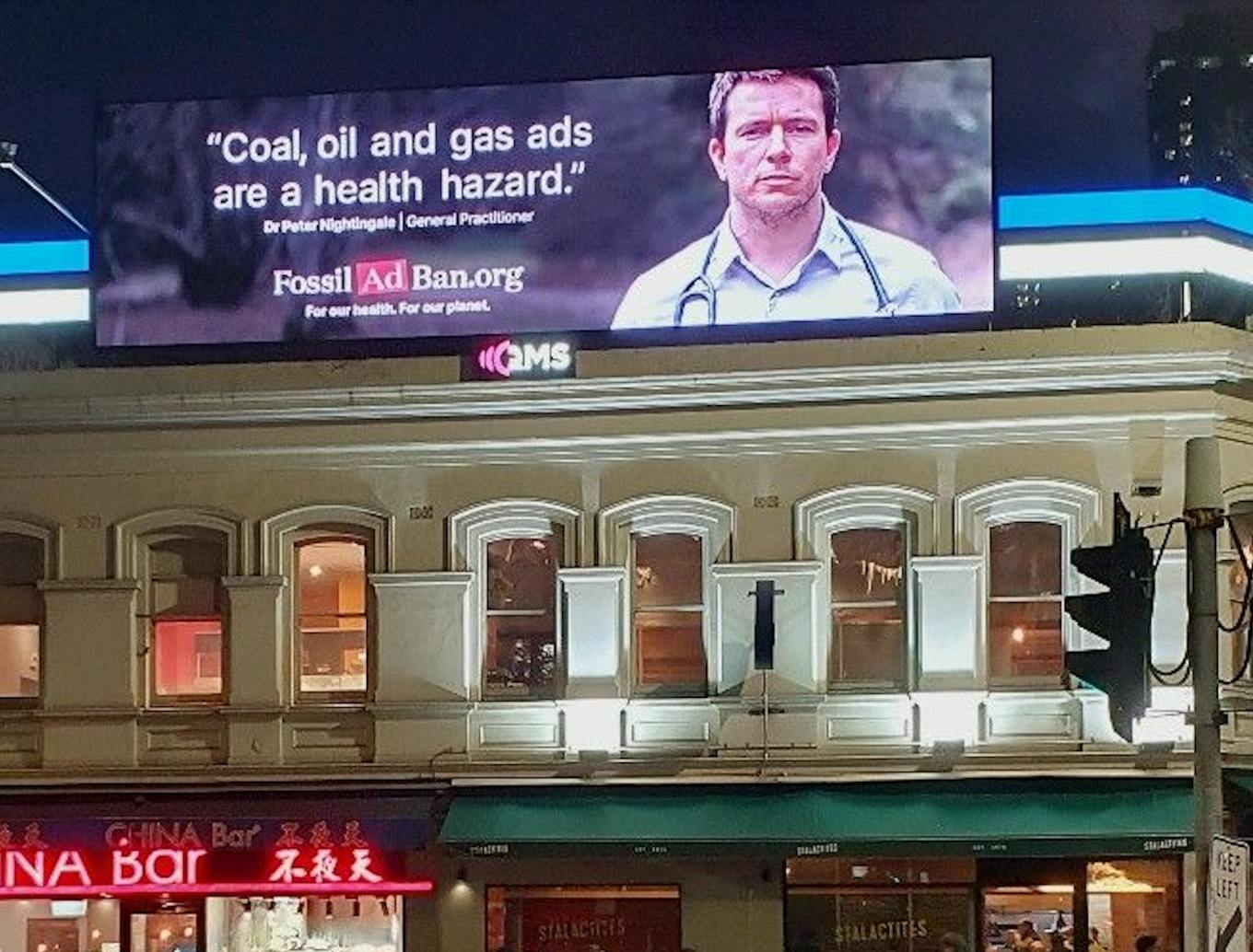 A billboard in Melbourne's central business district calling for fossil fuel ad ban