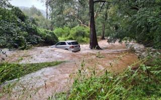A car floats down a flood torrent in New South Wales, Australia