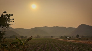 Haze lingers over farmland in northern Thailand, where seasonal crop burning has been exacerbated by high temperatures and dry weather.