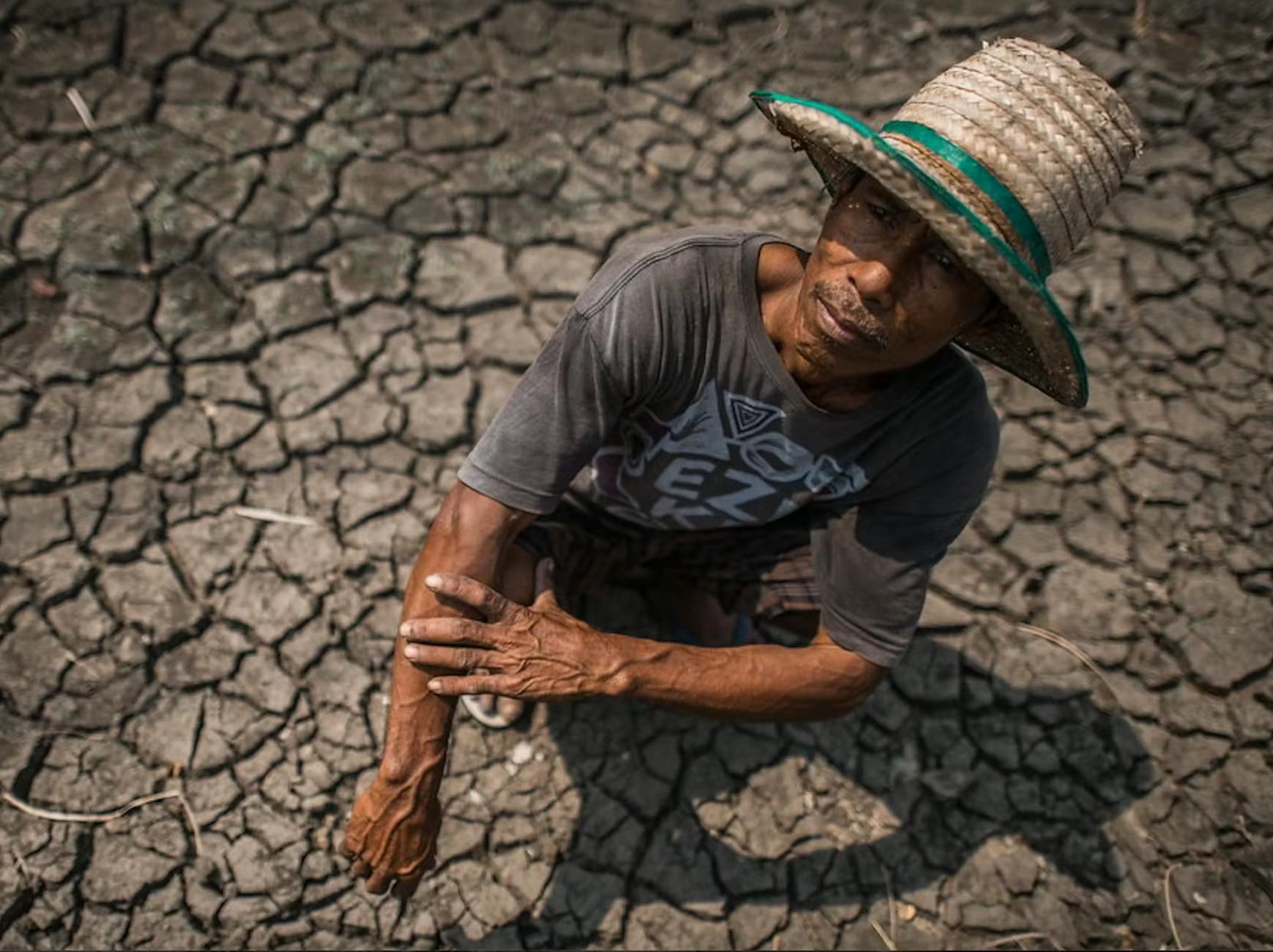 A farmer tends to his parched field in Thailand